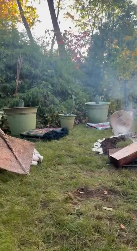 A garden ceremony space with cactus plants and a fire circle
